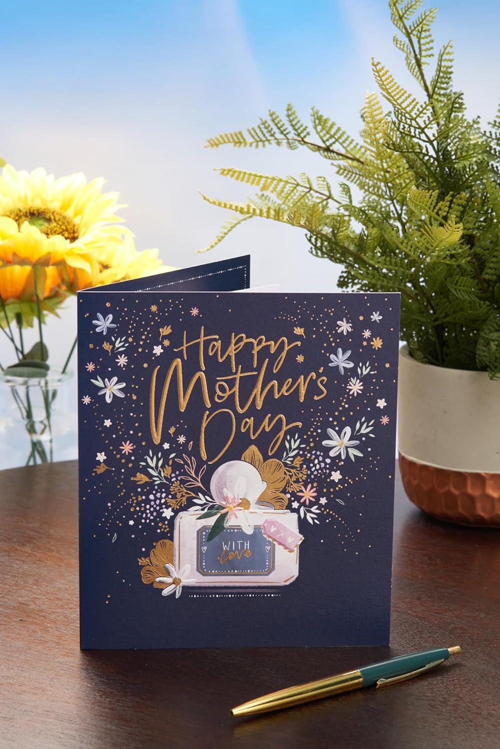 UK Greetings Mother's Day card featuring a stunning perfume design with elegant floral accents, perfect for celebrating moms.