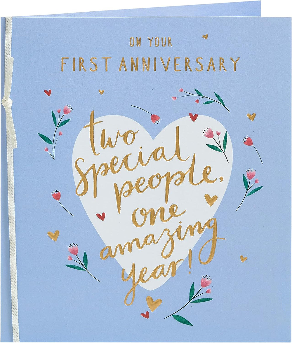 UK Greetings Sweet Design First Anniversary Card featuring colorful floral and heart illustrations on a cheerful greeting card.