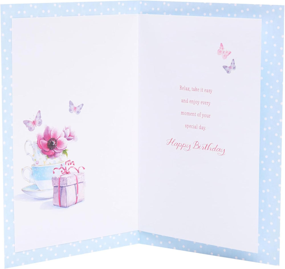 UK Greetings teacups design birthday greeting card with colorful teacup illustrations on the front.