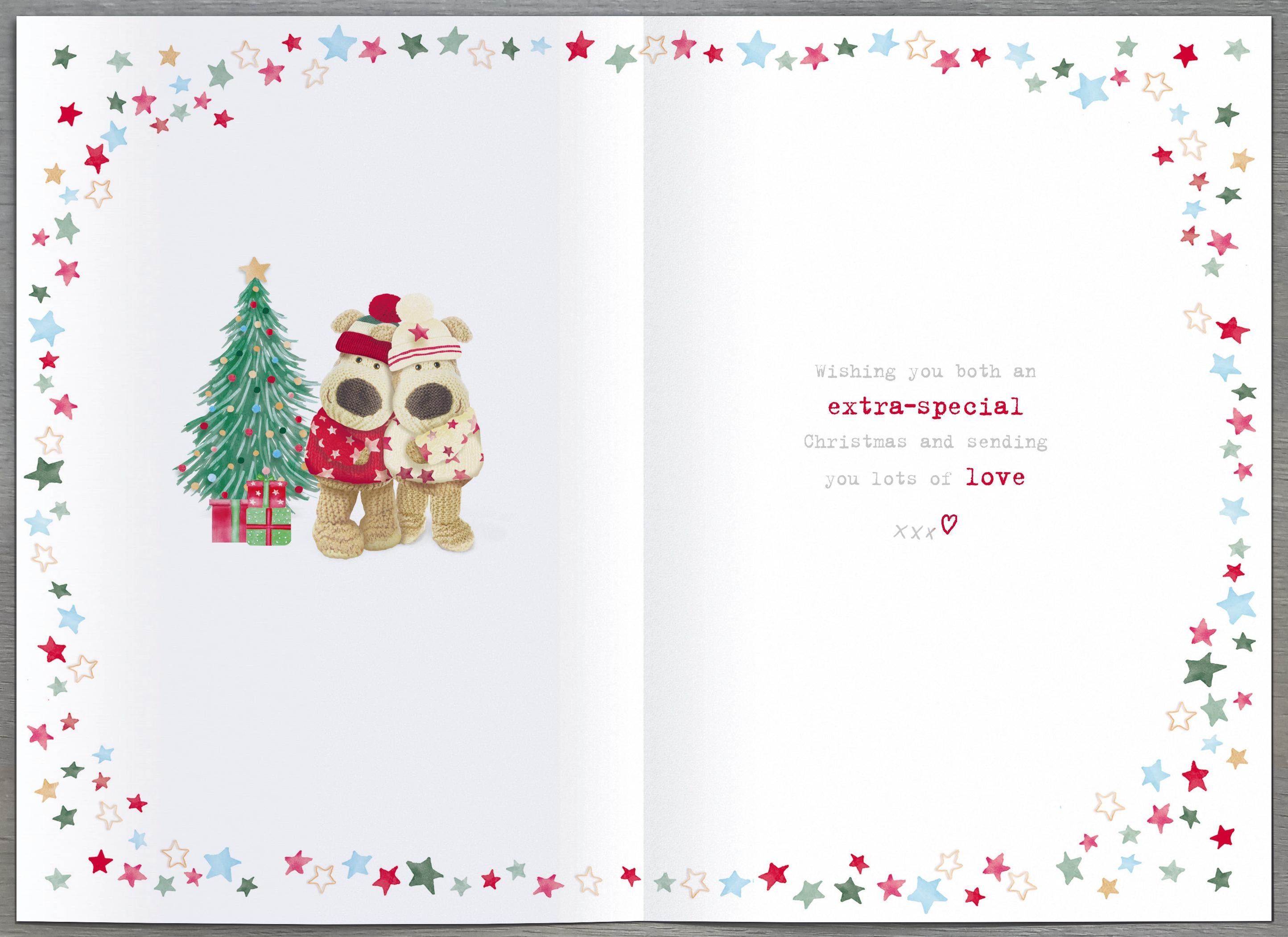 UK Greetings Christmas card featuring two Boofles characters standing with arms out, celebrating festive holiday cheer.