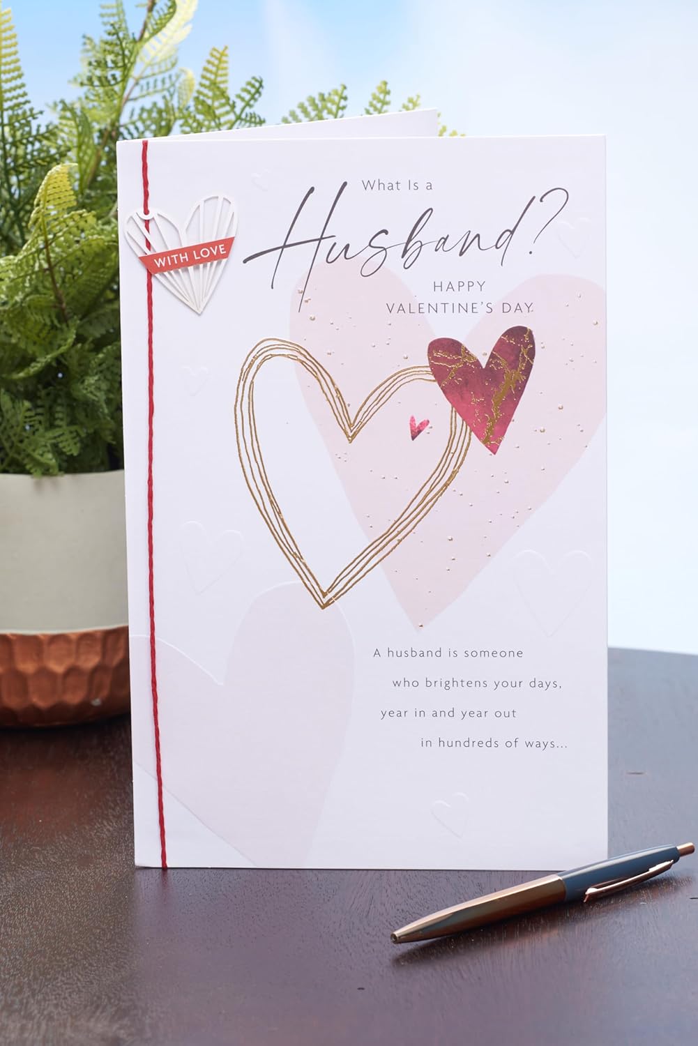 UK Greetings Valentine's Day card for husband featuring a "What Is a Husband?" design, showcasing romantic greeting card artwork.