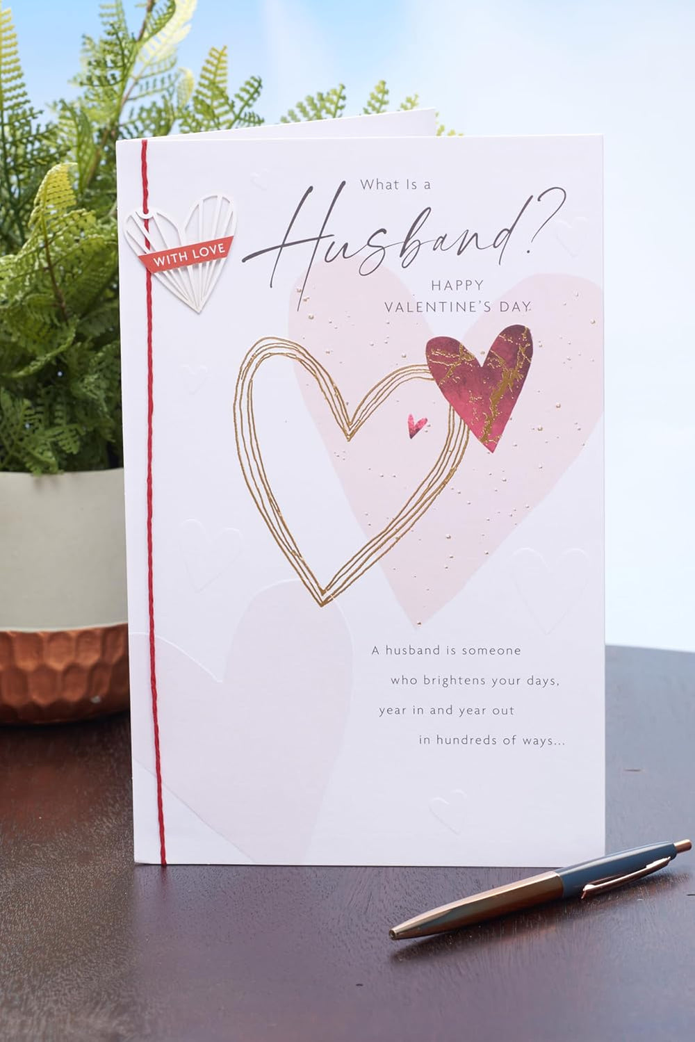 UK Greetings Valentine's Day card for husband featuring a "What Is a Husband?" design, showcasing romantic greeting card artwork.