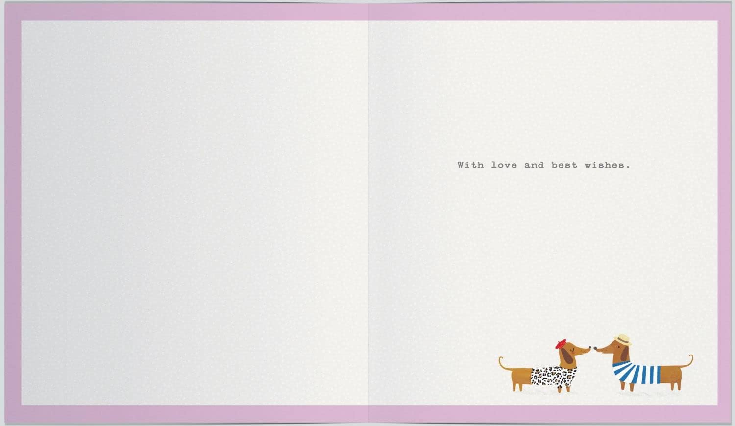 UK Greetings anniversary greeting card featuring playful sausage dogs and bunting, with a subtle watermark design.