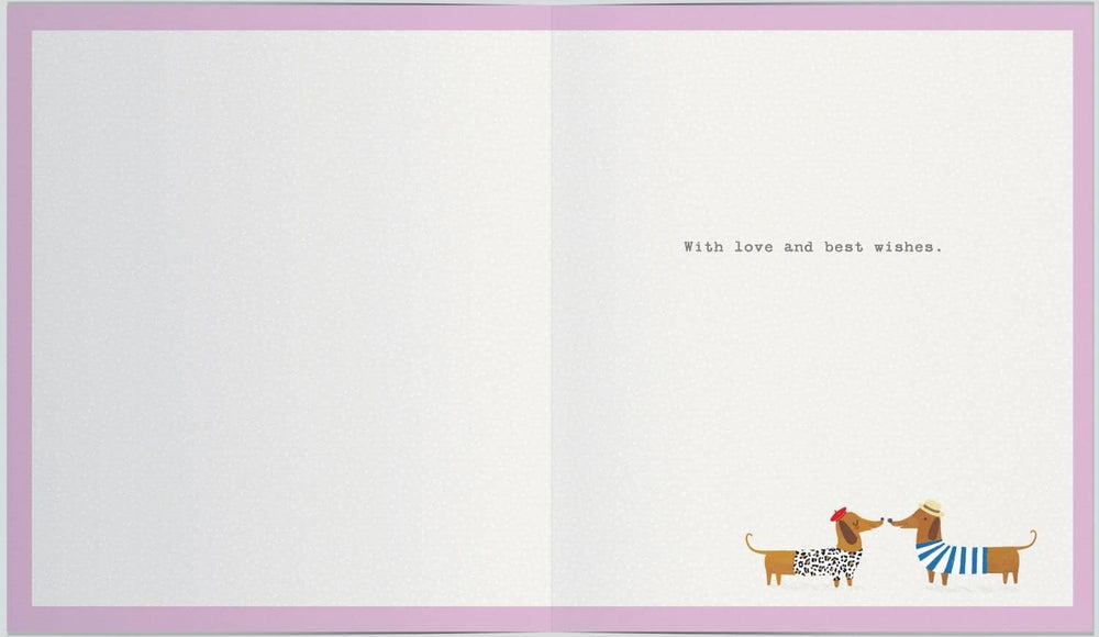 UK Greetings anniversary greeting card featuring playful sausage dogs and bunting, with a subtle watermark design.