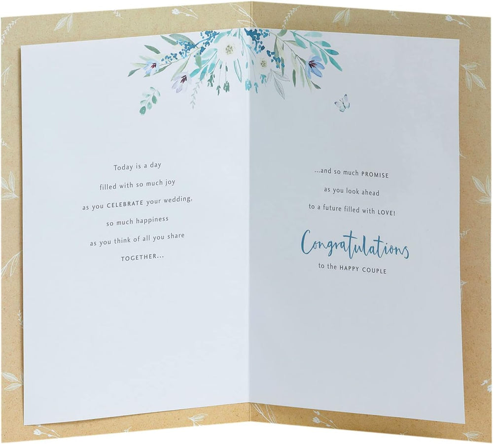 UK Greetings wedding greeting card for him, her, or friend featuring a white flower design and elegant floral artwork.