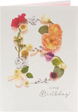 UK Greetings Into the Meadow female birthday card featuring floral and nature-themed illustrations on stationery.