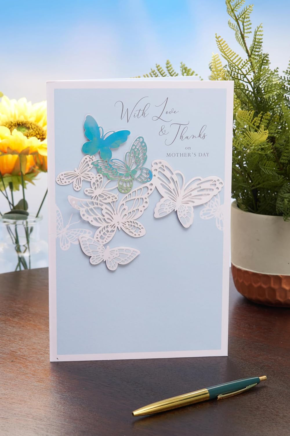 Light blue UK Greetings Mother's Day card for her, featuring elegant floral design, ideal for expressing love and appreciation.