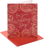 UK Greetings wedding card featuring a bride and groom design with red and gold accents on a elegant, celebratory wedding card.